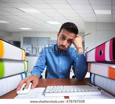 Man doing a boring job on his computer