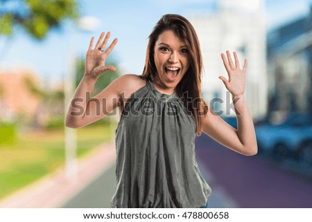 Young girl doing surprise gesture on unfocused background