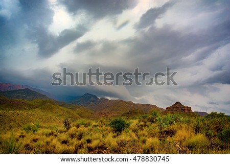 Rain falls distant in the Chisos Mountains at Big Bend National Park, which contains the Chihuahan Desert, in West Texas. Royalty-Free Stock Photo #478830745