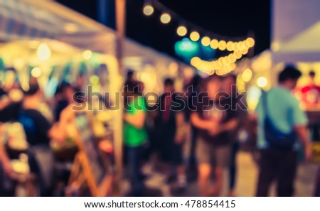 vintage tone blur image of night festival on street blurred background with bokeh.