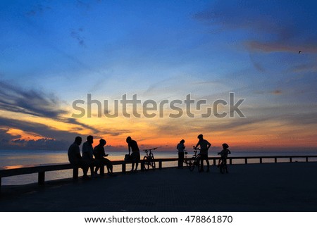 Family enjoying and bike the sunrise on the beach