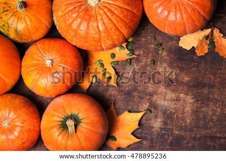  Autumn Pumpkin Thanksgiving Background - orange pumpkins over wooden table  Royalty-Free Stock Photo #478895236