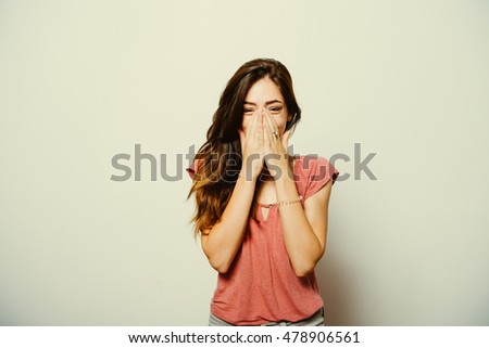Girl laughs and covers her mouth