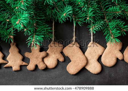 Christmas wooden background with fir tree,Gingerbread Cookies and holiday decor