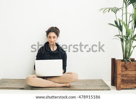 Young beautiful woman with laptop notebook on floor home surfing internet 