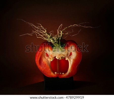 Red peppers angry shouts. Red pepper evil looking on a dark background. Halloween.