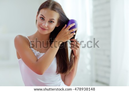 Bright picture of beautiful woman with comb