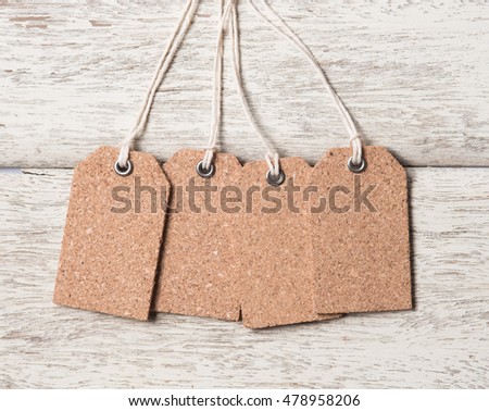 Blank natural cork label tag on wood background