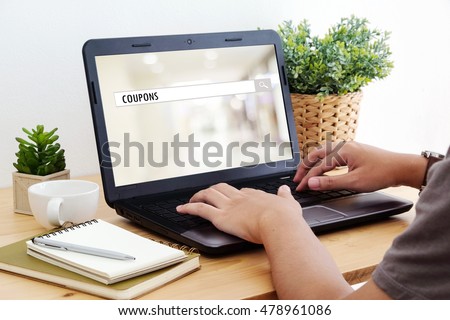 Coupon word on search bar over blur store background on screen, digital marketing, business and technology