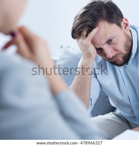 Photo of man with depression talking with counselor