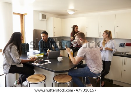 Students Relaxing In Kitchen Of Shared Accommodation Royalty-Free Stock Photo #479010157