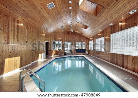 Swimming pool in luxury home with wood paneled ceiling
