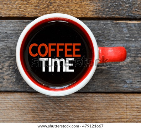 Coffee time./ Inscription time for coffee in a cup of coffee and wooden background.
