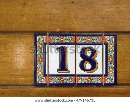 Number eighteen and wooden background