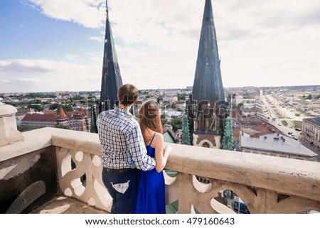 Boy hugs his girlfriend on the top of city