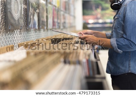 Man browsing vinyl album in a record store Royalty-Free Stock Photo #479173315