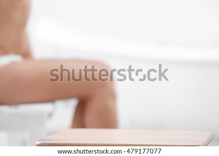 Wooden stool in bathroom on blurred background