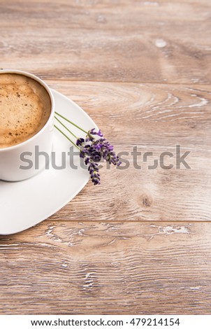 A cup of coffee on wooden background with lavenders. Good morning background with copy space 