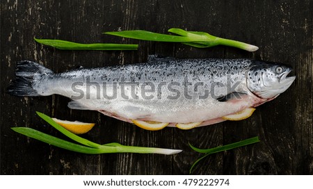 Fresh whole salmon on a rustic table. Flat lay. Healthy food  concept.