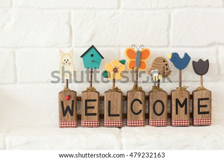 Wooden word sign at home on white cement wall background.