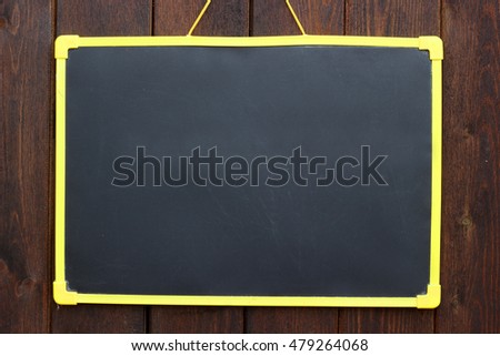 Chalk board hanging on wooden background