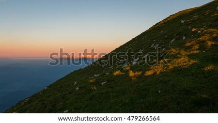 Mystic sunrise with rolling fog in the mountains. Mountain scenery from the Alps.
