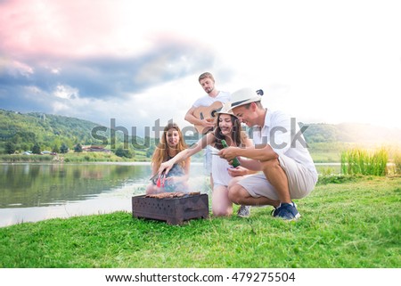 Young people enjoy and eat grill in nature.Colored and Under exposed photo