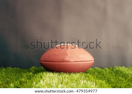 Football on grass and black background