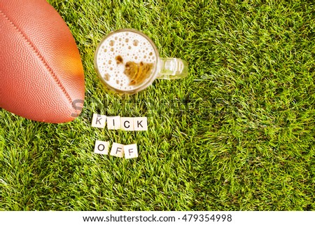 Football and beer jar on grass and Kick Off message