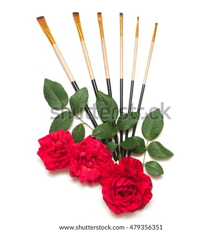 Beautiful red roses flowers and brush for drawing isolated on a white background. Flat lay, top view. Greeting card