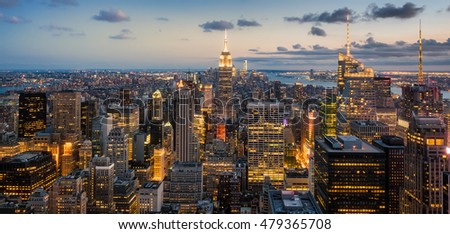 Beautiful panoramic aerial view of New York City at sunset with all the buildings and skyscrapers illuminated