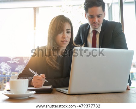 Businessman and businesswoman working in office


