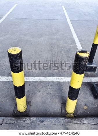 Black and yellow pole in Parking Garage space