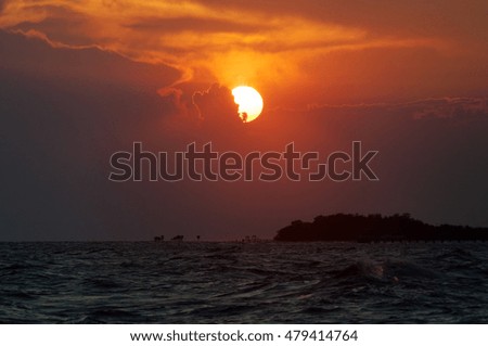 Beautiful sunset at the sea, subject is blurred and low key