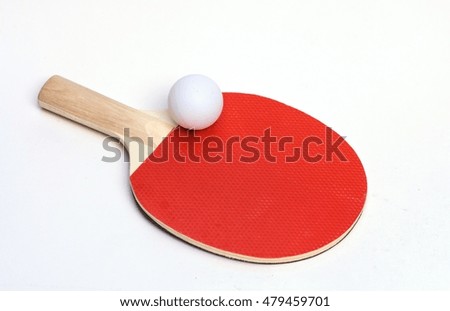 a red paddle  table tennis racket with white ball.