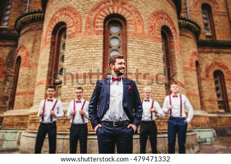 Young groom and his funny friends groomsman posing for camera. Group of young men with bow tie. Cheerful friends. friends outdoors. Wedding day. Royalty-Free Stock Photo #479471332