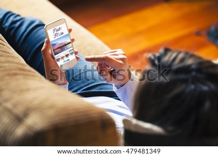 Woman using photo filters on a mobile phone while lying on the sofa. Generic app template design.