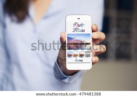 Woman holding a mobile phone with photo filters app on the screen. Generic app template design.