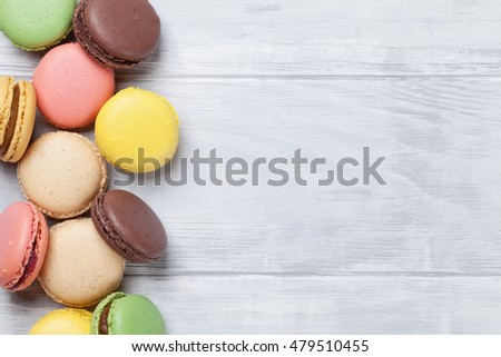 Colorful macaroons on wooden table. Sweet macarons. Top view with copy space for your text