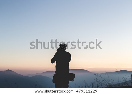 landscape view of great mountains and man silhouette,taking picture of panorama, wild, pro nature concept