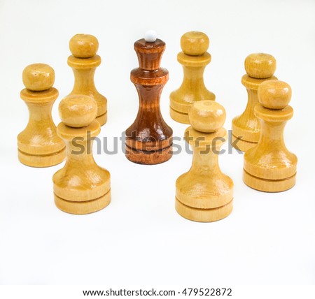 lack king surrounded by white pawns on a white background