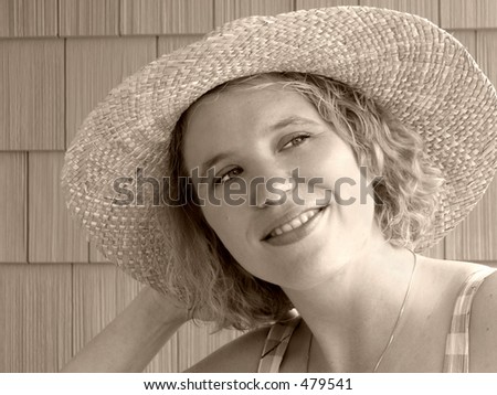 Pretty woman in straw hat; toned for an old-fashioned look