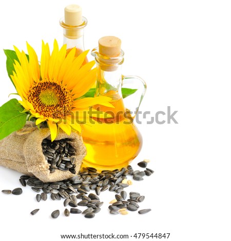 Sunflower seeds on a background of small bag with flower and a bottle of oil