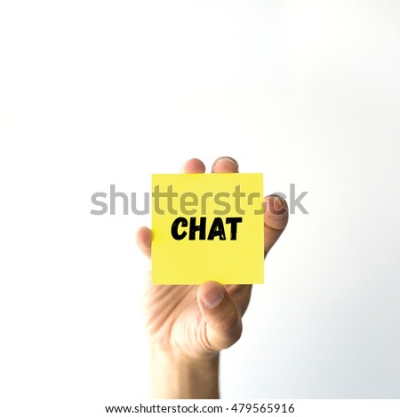 Hand holding yellow sticky note written CHAT 