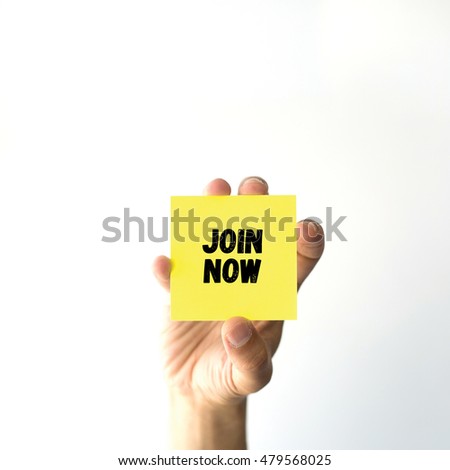 Hand holding yellow sticky note written JOIN NOW 
