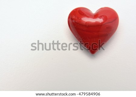 Valentines Day background with red glass heart on white background