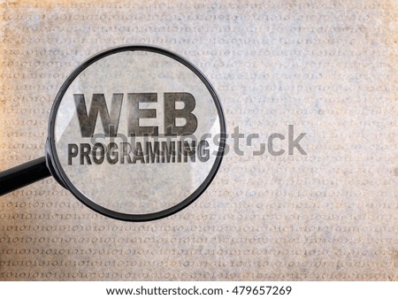 Web Programming. Magnifying optical glass on old paper background 