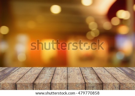 empty wood table top on Blur cafe restaurant with abstract bokeh light background