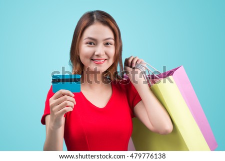 Young asian girl with credit card and shopping bags