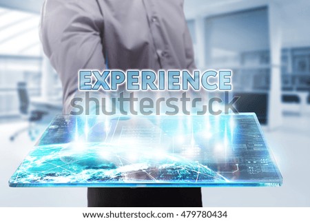 Business, Technology, Internet and network concept. Young businessman working on a tablet of the future, he sees the inscription: experience